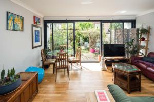 a living room with a couch and a table at Kennington 3BR Haven: Dog-Friendly/Central London in London