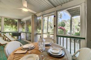 a dining room with a table and chairs on a balcony at Live Oak by AvantStay Walk to Folly Beach in Folly Beach