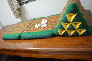 a table topped with an inflatable cushion with golf balls at 28 Rachabutr Hostel in Ubon Ratchathani