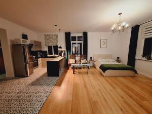 a large bedroom with a bed and a kitchen at agroturystyka Drużno in Elblag