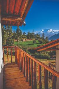 a stairway to a cabin with mountains in the background at Nápoles Ecolodge Hotel in Anta