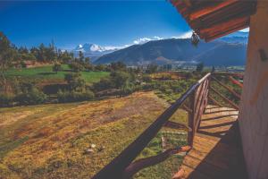 a view from the porch of a house with mountains in the background at Nápoles Ecolodge Hotel in Anta