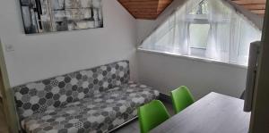 a room with a bench and a table and a window at Apartma PeMaks, Terme Olimia in Podčetrtek +24 photos