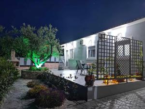 a house with a gate and a garden at night at Il Mio Riposo in Vasilikos