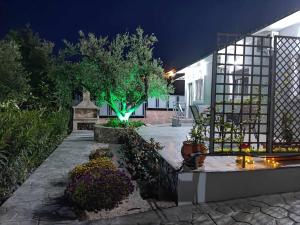 a house with a garden at night with lights at Il Mio Riposo in Vasilikos