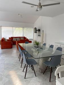 a living room with a glass table and chairs at CASA BLANCA in Cancún