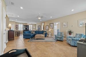 a living room with blue couches and a table at Points of View in Gulf Shores