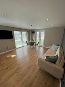 a living room with a couch and a table at IVI Granton Harbour Apartment in Edinburgh