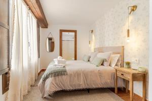 a bedroom with a large bed and a table at Apartamento San Bartolome Albaicin in Granada