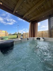 a jacuzzi tub with a view at Spa Garden Cottage - Upper Hopton in Mirfield