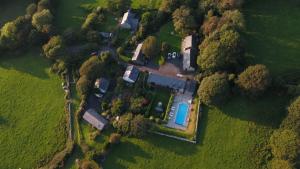 an aerial view of a house in a field at The Old Farmhouse B&B in Dyffryn
