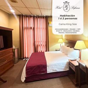 a hotel room with a bed and a desk and a tv at Hotel Reforma Tuxpan in Tuxpan de Rodríguez Cano