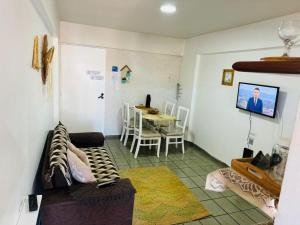 a living room with a couch and a table at Praia de Ponta Verde com lavadora, wi-fi, garagem - quarto andar in Maceió