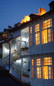 a large white building with lit windows at night at Guest House Goari in Tbilisi City