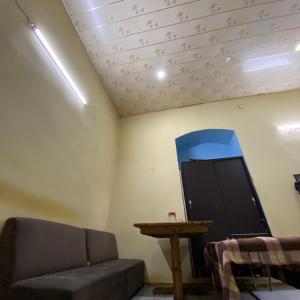 a living room with a couch and a table at Shaan E Punjab HOSTEL in Baku