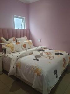 a bedroom with two beds with white blankets and pillows at Home Stay Accommodation in Cape Town