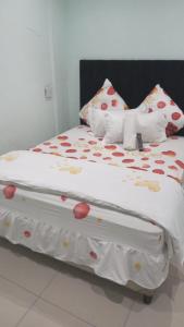 a large bed with red hearts on it at Home Stay Accommodation in Cape Town
