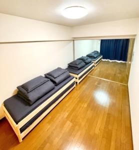 a row of beds in a room with wooden floors at Purezant - Vacation STAY 37459v in Orio