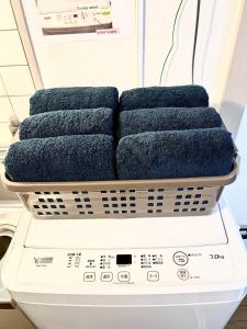a washing machine with three blue towels on it at Purezant - Vacation STAY 37459v in Orio