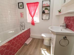 a bathroom with a tub and a toilet and a sink at 36 High Street in Salisbury +31 photos