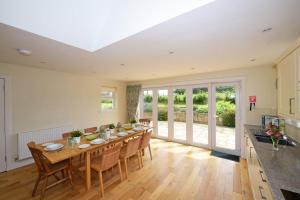 a kitchen and dining room with a table and chairs at Hawthorn House in Pathhead