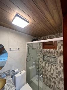 ein Bad mit einer Dusche, einem WC und einem Waschbecken in der Unterkunft Serra Chalés in Serra de São Bento