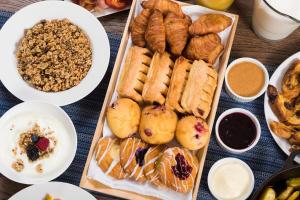 a table topped with different types of pastries and other foods at The Cassara Carlsbad, Tapestry Collection By Hilton in Carlsbad