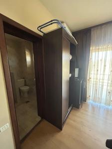 a room with a bathroom with a toilet and a door at Casa Andrei Maria in Eforie Nord