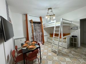 a room with a table and two bunk beds at Casa Planet Rapallo in Rapallo