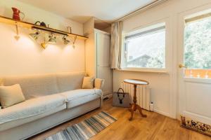 - un salon avec un canapé et une fenêtre dans l'établissement Alpes Bellevue furnished flat, aux Houches
