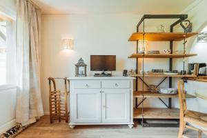 Habitación con armario blanco y TV. en Alpes Bellevue furnished flat, en Les Houches