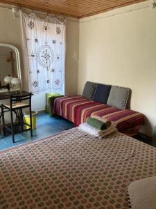 a bedroom with two beds and a window at Rural house in Vignai