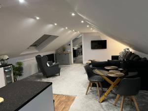 a living room with black chairs and a table at Waters Edge, Eaton in Congleton