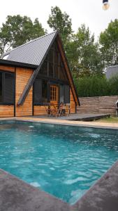 a small cabin with a swimming pool in front of it at Pentalow Cabin in Kocaeli