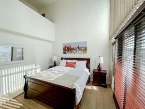 a bedroom with a bed and a large window at *WEHO/Beverly Hills* Luxury 2BD/2.5BA + Balconies in Los Angeles