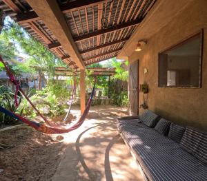 a porch with a hammock in a house at Cabañas La Escondida Mazunte in Mazunte