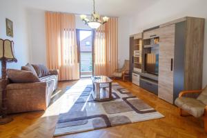 a living room with a couch and a table at Barok Appart in Braşov