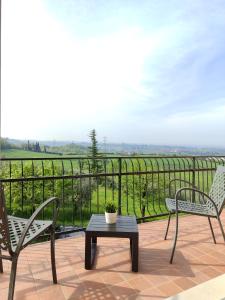 a patio with two chairs and a table with a view at Nice apartment lake view & free parking in Pastrengo