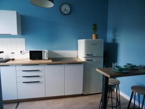 uma cozinha com um frigorífico branco e uma mesa em Joli cocon - Dijon centre ville em Dijon