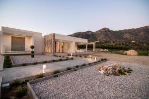a house in the desert with mountains in the background at DS Luxury House in Kos