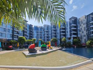 a swimming pool in a city with apartment buildings at Laguna cassia residences in Bang Tao Beach