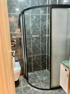 a shower with a glass door in a bathroom at Bonita Hotel in Istanbul