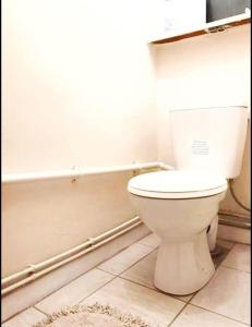 a bathroom with a white toilet and a tub at Close to Central London in London