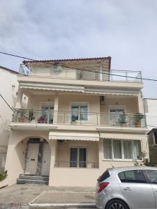 une maison avec une voiture garée devant elle dans l'établissement Bozikis House! A cosy apartment in the city centre, à Skiathos Chora
