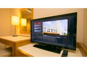 a flat screen tv sitting on top of a desk at Rembrandt Hotel Atsugi - Vacation STAY 41676v in Atsugi