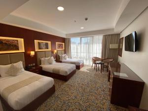 Postel nebo postele na pokoji v ubytování فندق الاء البيت Alaa Al Bayt Hotel