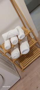 a pile of towels on a bamboo towel rack at Little Sweet Home - Fiera Milano in Pero