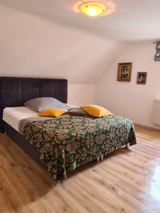 a bedroom with a large bed with a wooden floor at Ferienwohnung Bergischer Dreiklang in Windeck +18 photos
