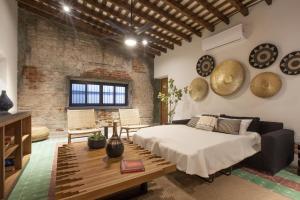 a loft bedroom with a bed and a table at Departamentos & Villa Monarka, 1 Block from Malecon! in La Paz +70 photos