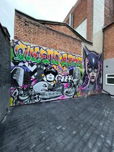 a wall covered in graffiti on the side of a building at Modern 7-BR Retreat All Ensuite in Birmingham